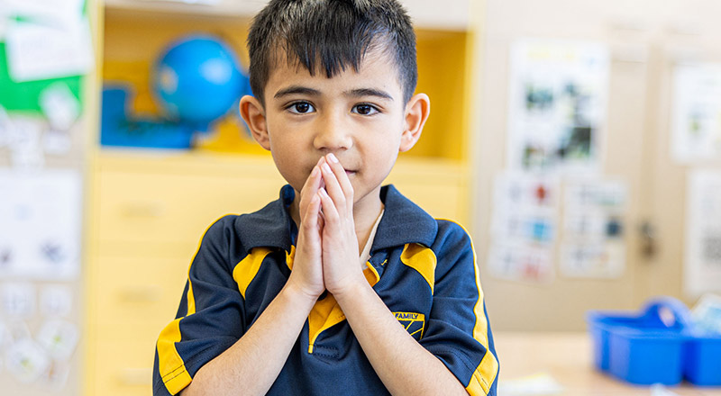 Boy praying at Holy Family Catholic Primary East Granville
