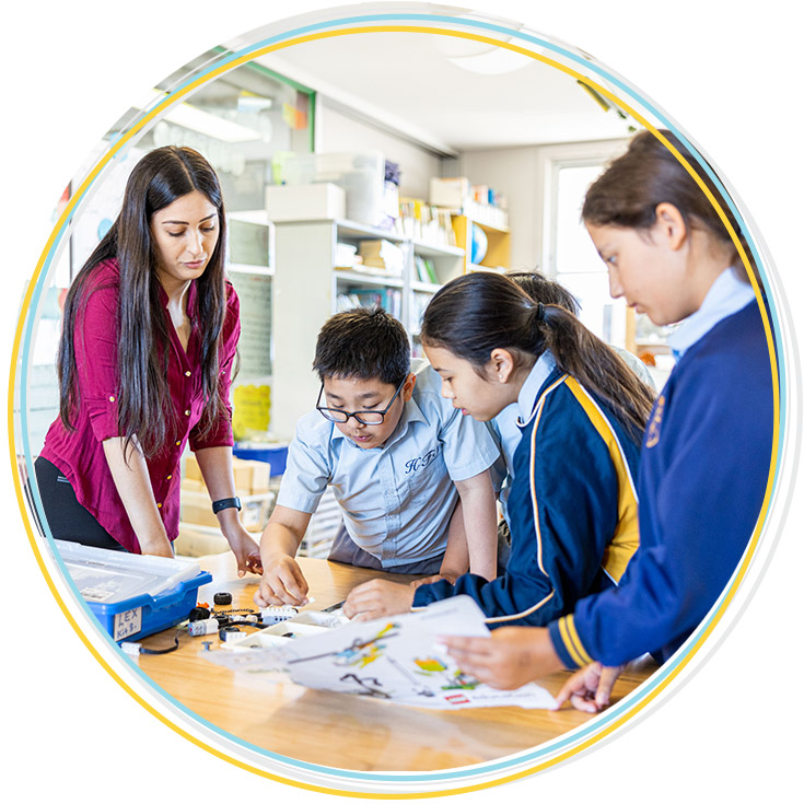 Teacher supporting students st Holy Family Catholic Primary East Granville