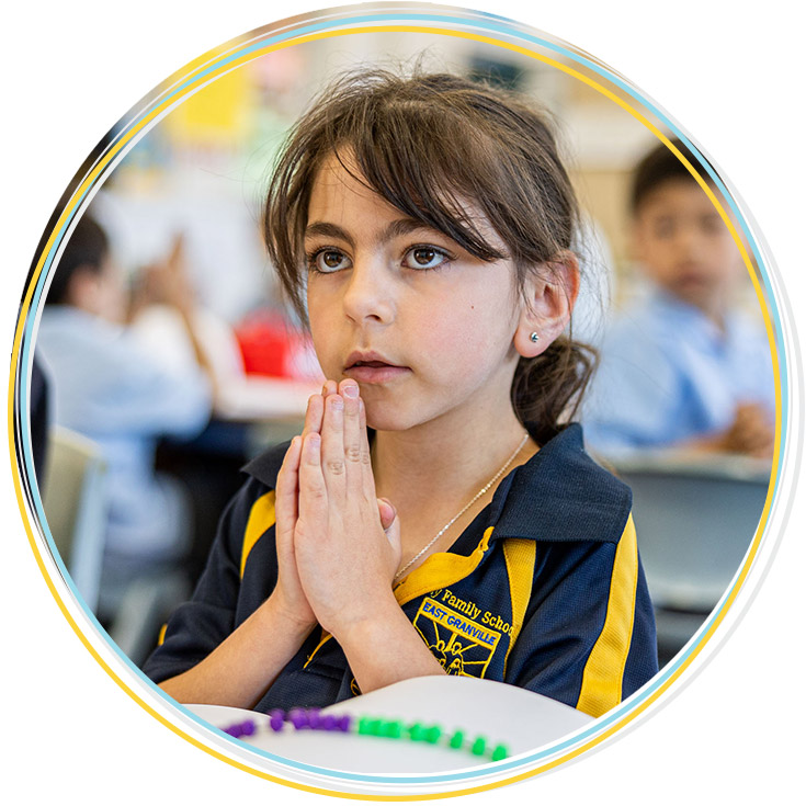 Girl praying in class at Holy Family Catholic Primary East Granville