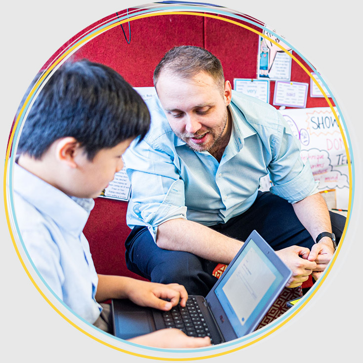 Teacher supporting at student at Holy Family Catholic Primary East Granville