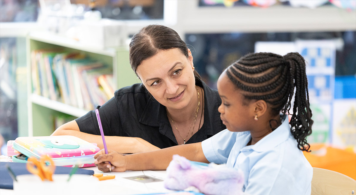 Teacher at Holy Family Primary, East Granville engaging with student learning