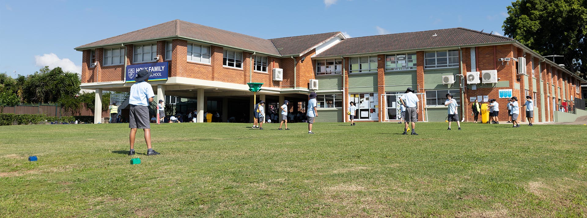 Students playing sports on the Holy Family Primary East Granville school grounds