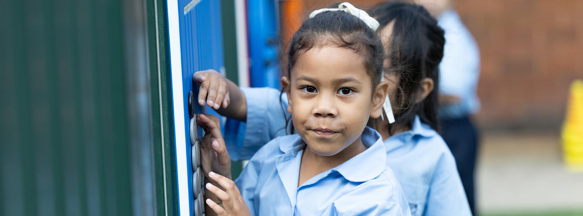 Holy Family Primary Emerton students playing on outdoor equipment