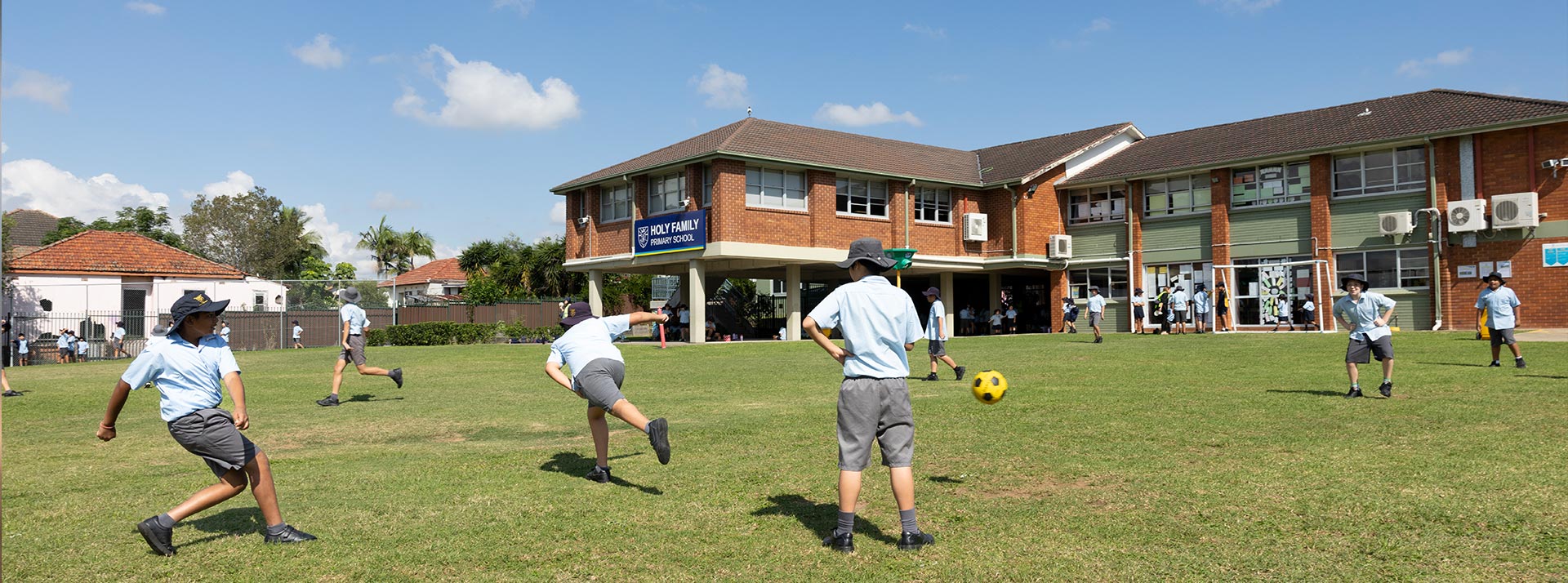 Students playing on the outdoor field at Holy Family Granville