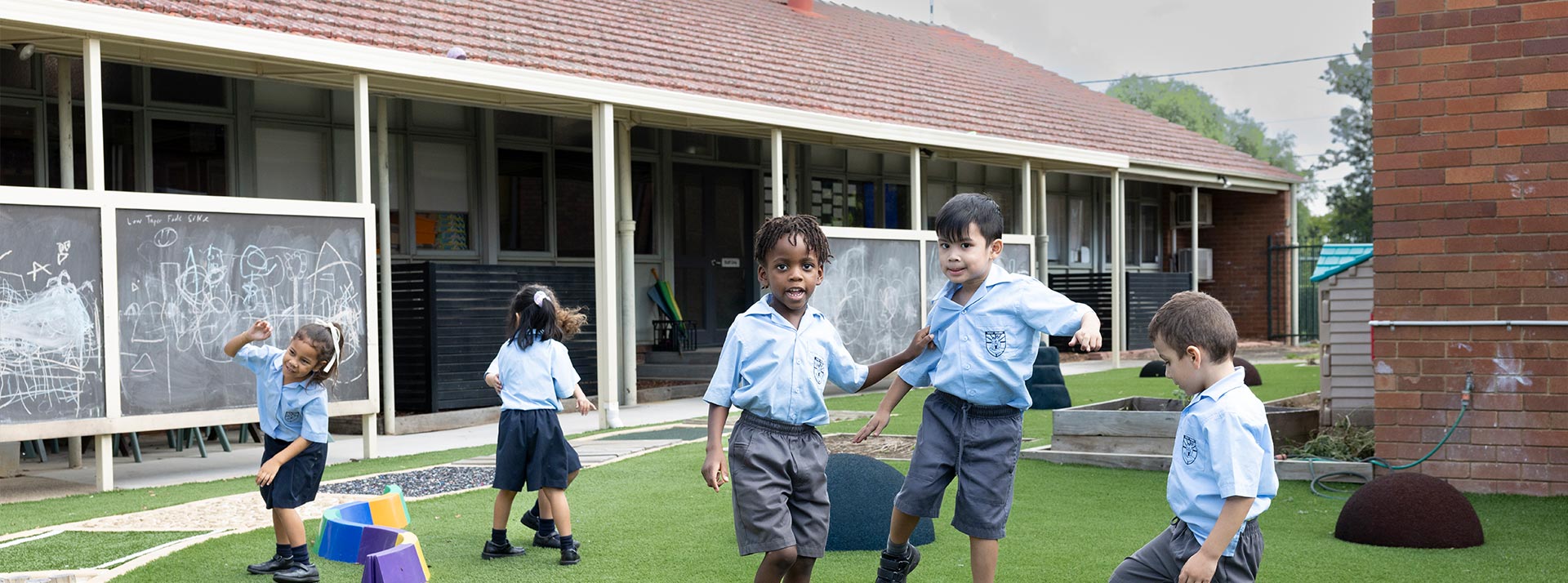 Group of Holy Family Primary students playing on the outdoor equipment
