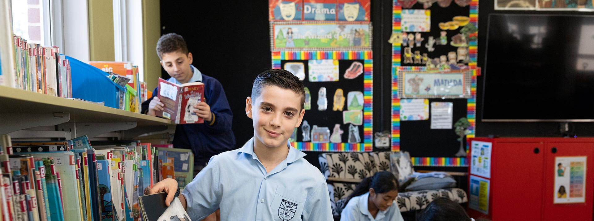 Holy Family Primary, East Granville students reading in the school library