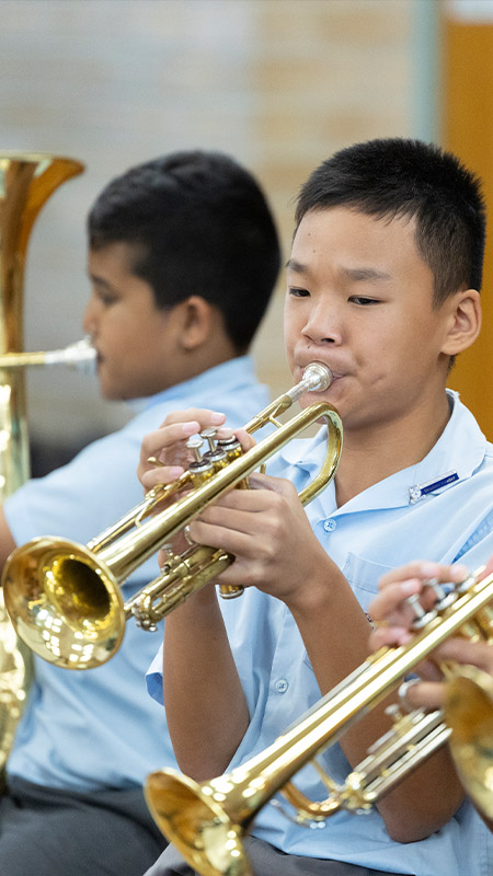 Holy Family Primary East Granville student playing trumpet