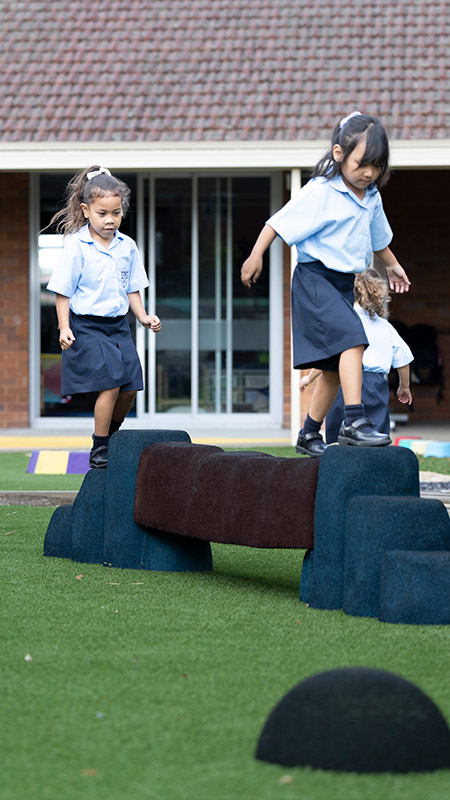 Holy Family Primary East Granville students on outdoor play equipment