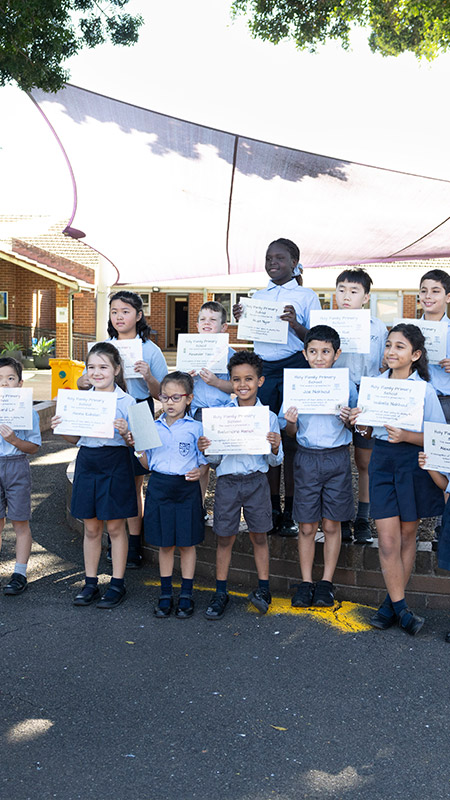 Holy Family Primary East Granville students presenting merit awards