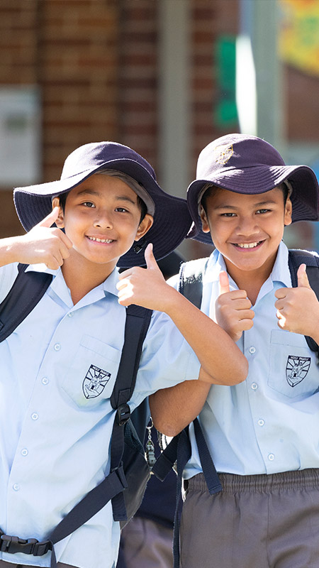 Two happy students from Holy Family Primary, East Granville giving the thumbs up