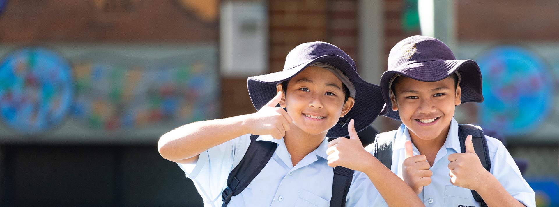 Two happy students from Holy Family Primary, East Granville giving the thumbs up