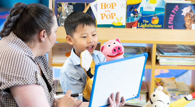 Holy Family Primary East Granville teacher reading to student