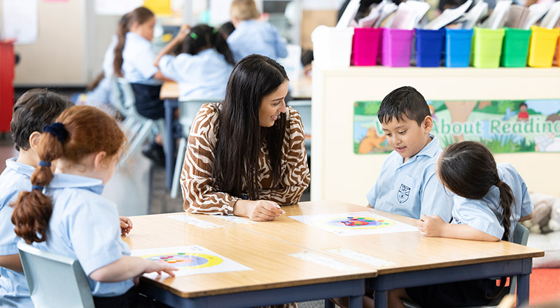 Holy Family Primary, East Granville teacher assisting group of students