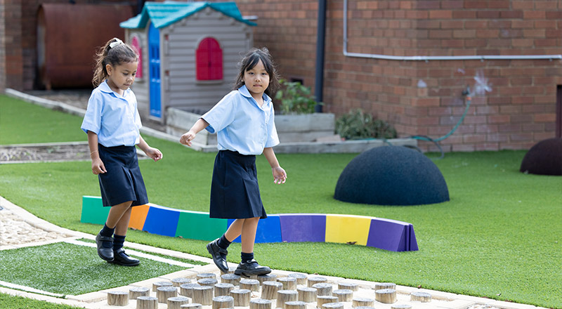 Holy Family East Granville students on outdoor play equipment