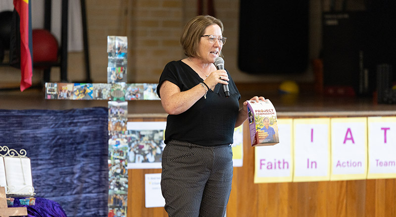 Holy Family Primary, East Granville teacher presenting Project Compassion donation box