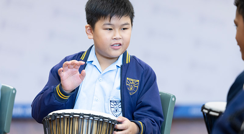 Holy Family East Granville Student playing a drum