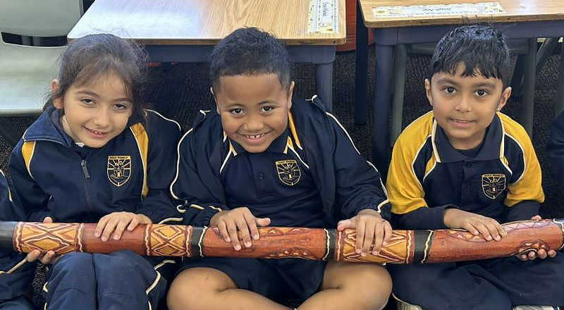 Holy Family Primary East Granville students holding didgeridoo
