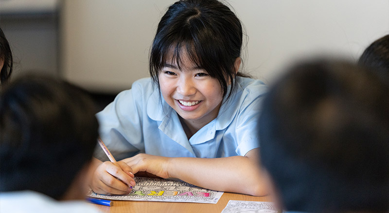 Smiling student in class at Holy Family Primary East Granville
