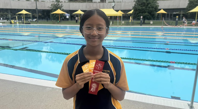 Holy Family Primary East Granville student competing at Parramatta Aquatic Centre