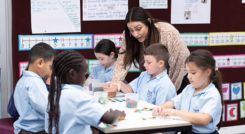 Holy Family Primary East Granville students in class receiving support from teacher