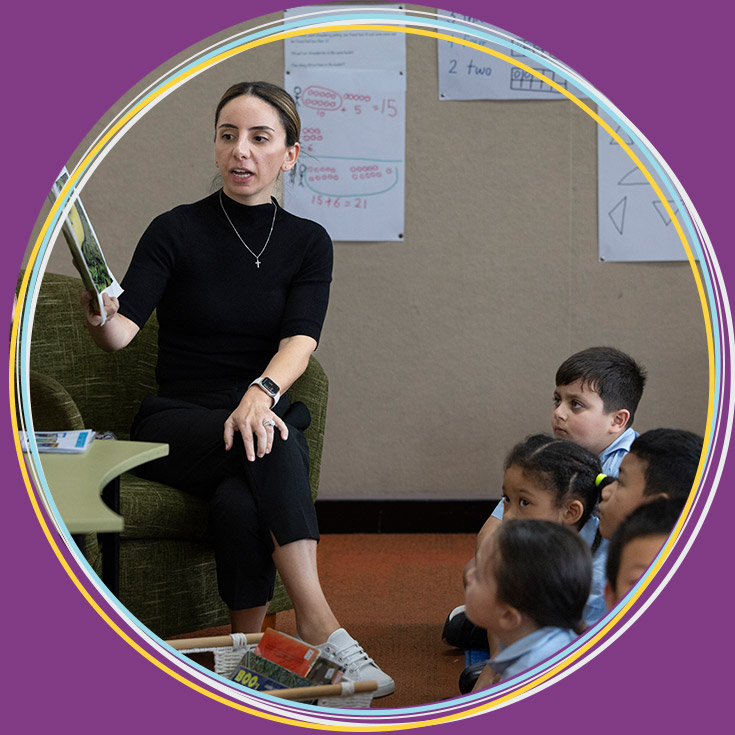 Teacher reading to Holy Family Primary, East Granville students