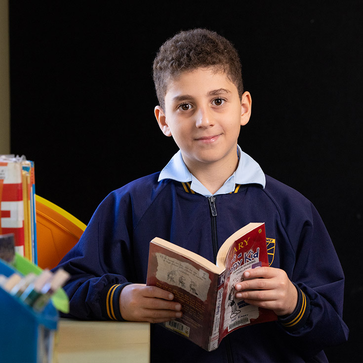 Holy Family Primary East Granville student reading a book