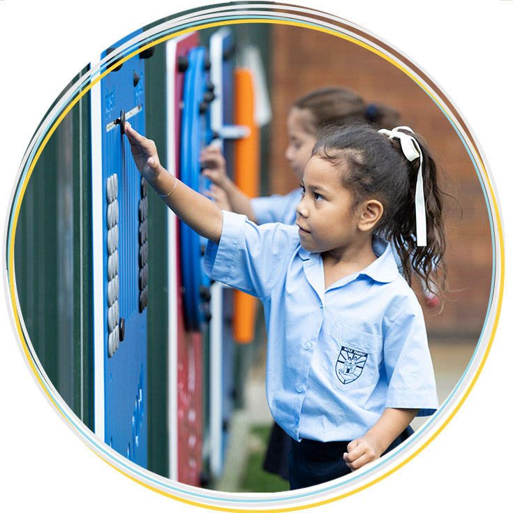 Stage 1 student at Holy Family East Granville playing on playground equipment