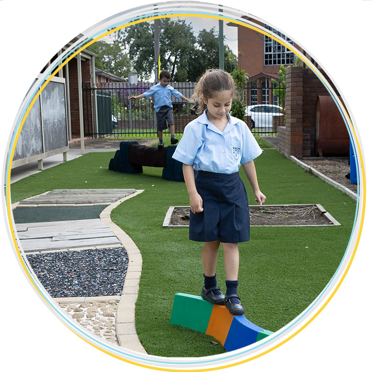 Student balancing on outdoor play equipment