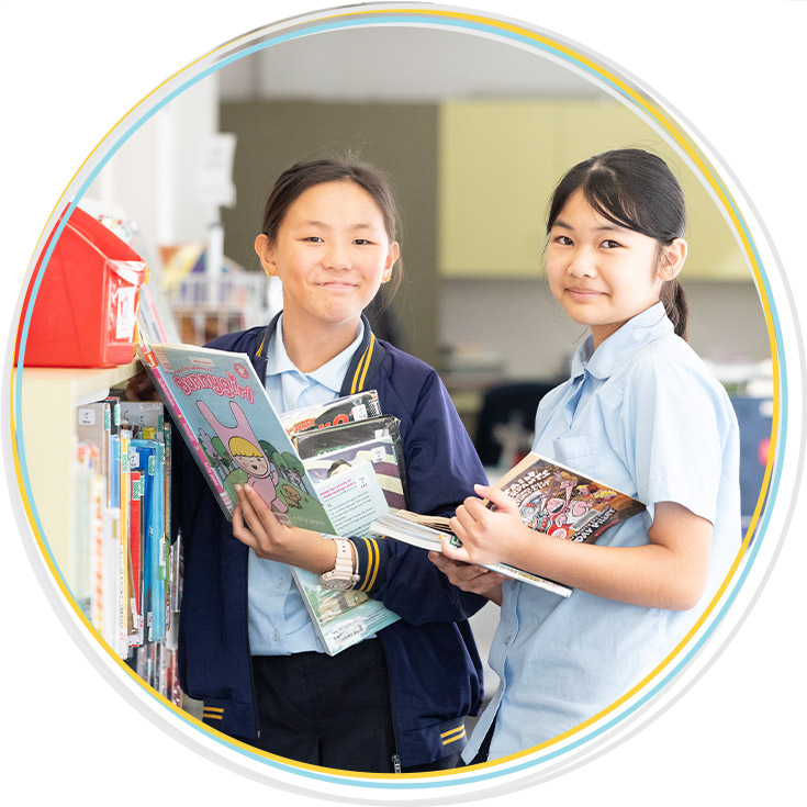 Students from Holy Family Primary, East Granville borrowing books in the school library
