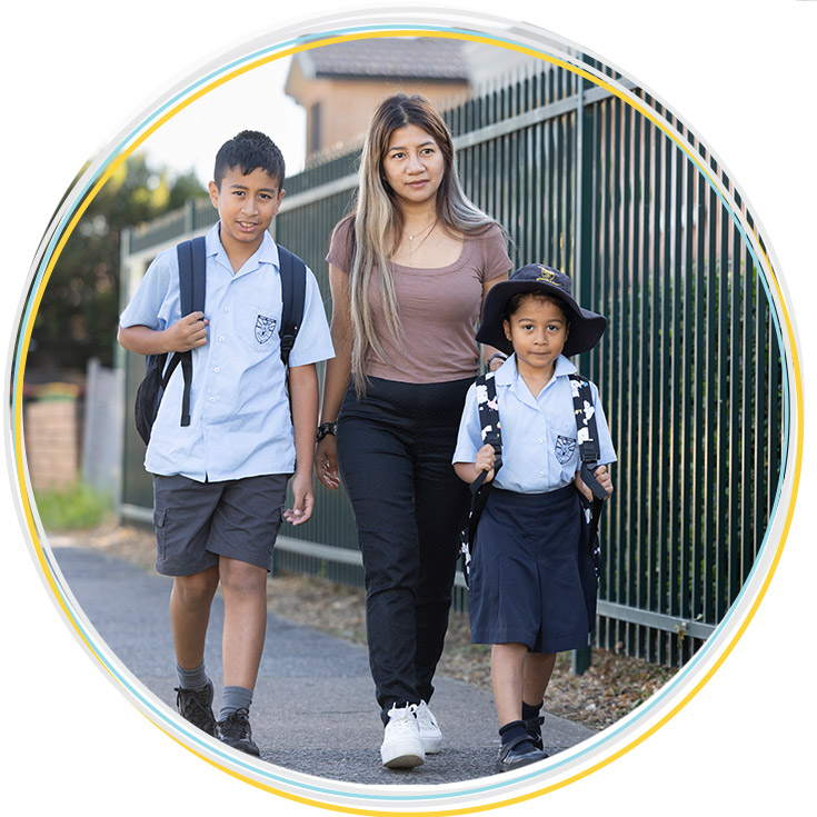 Mum walking daughter and son to Holy Family Primary school gates