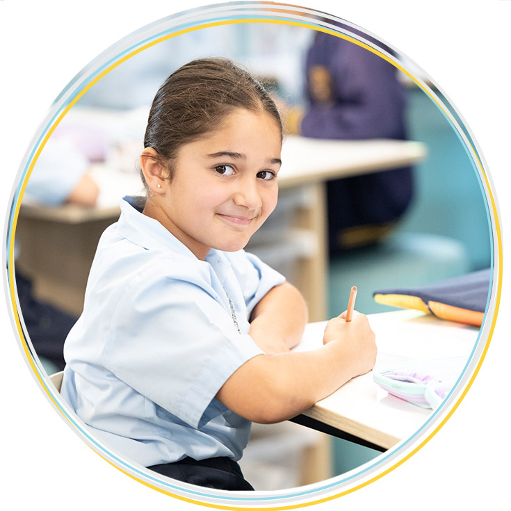 Holy Family Primary East Granville student penciling into workbook