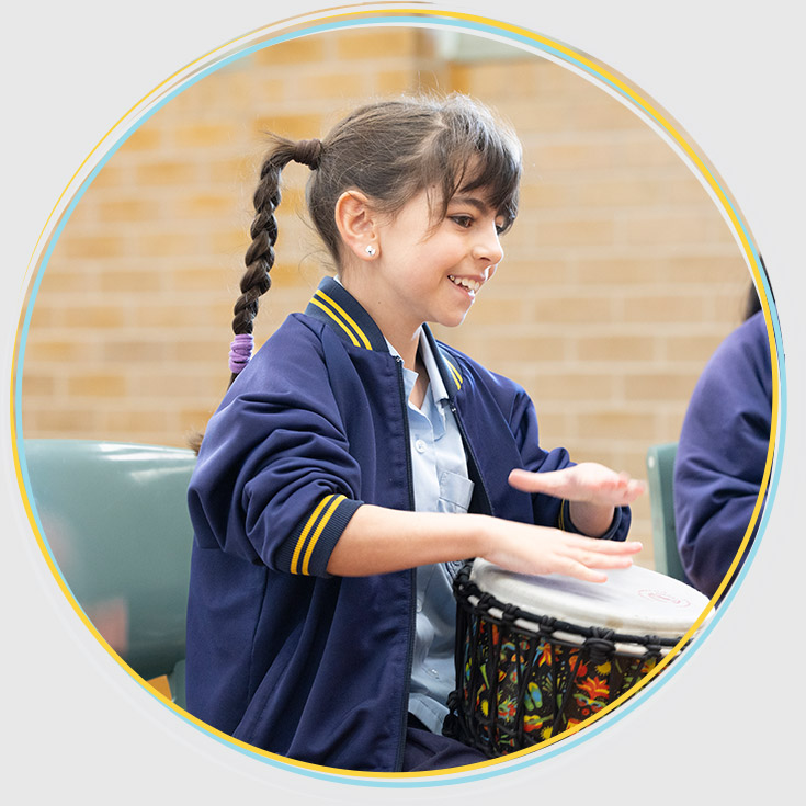 Holy Family Primary, East Granville student playing drums