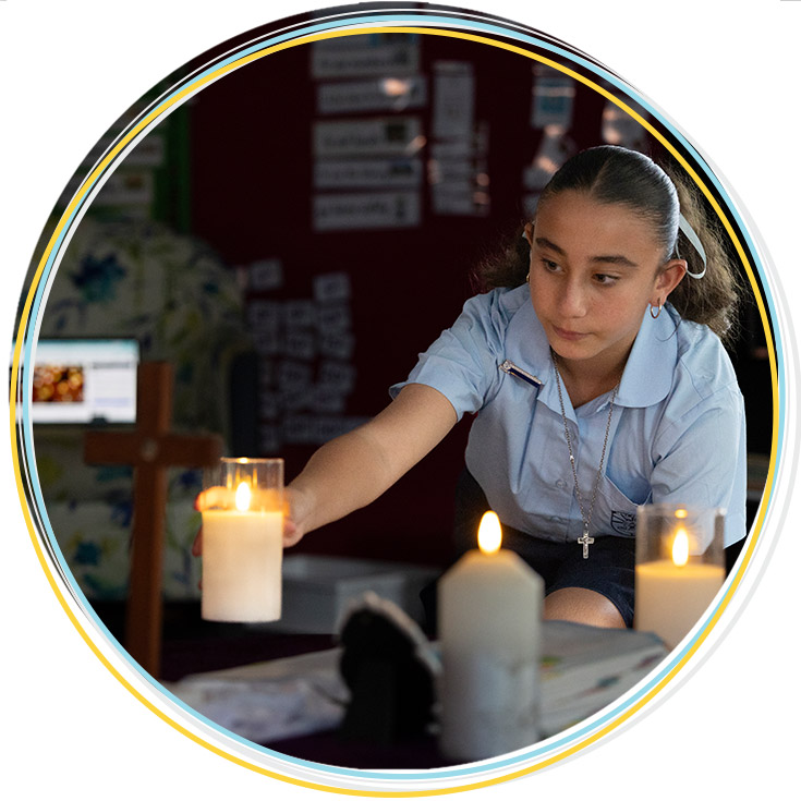 Holy Family Primary, East Granville student lighting liturgical candle